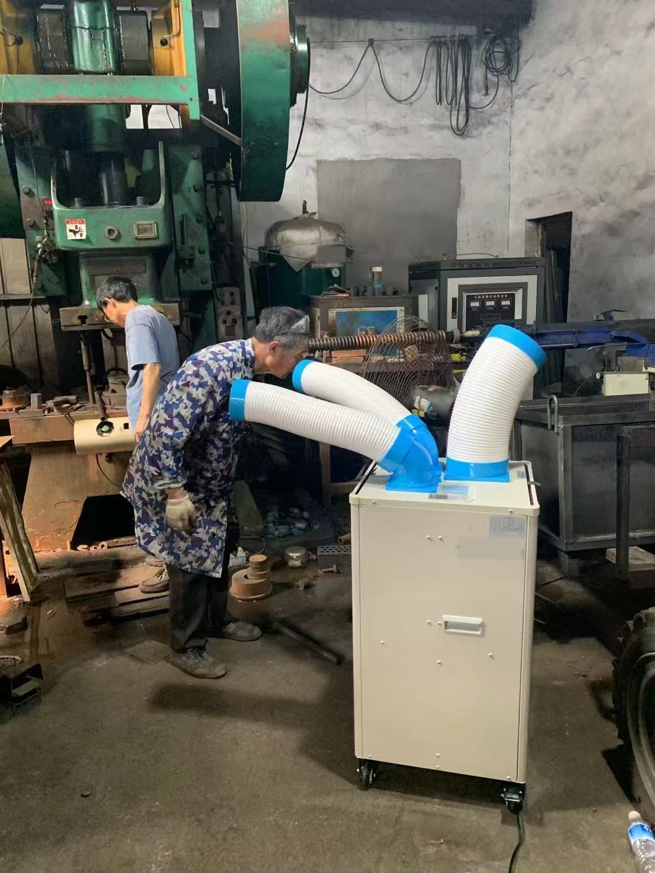 Portable air cooler in a factory workshop